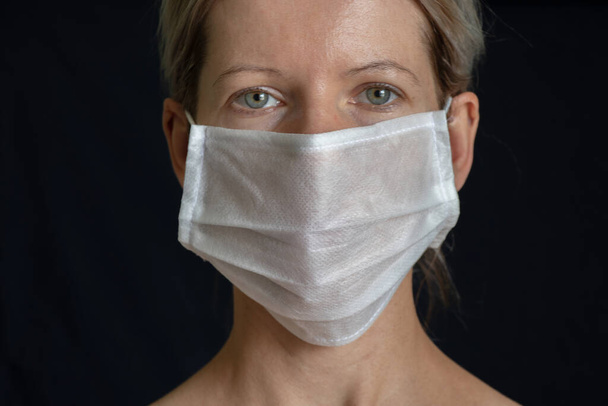 Menina ucraniana em máscara médica retrato no escuro
 - Foto, Imagem