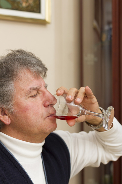 Senior man drinking red wine - Photo, Image