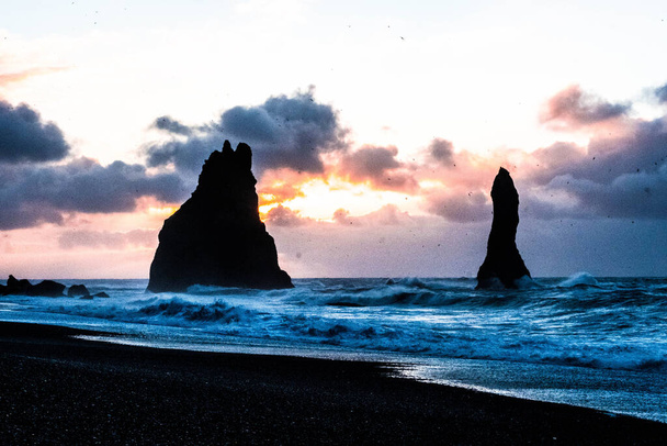 The rocks of Reynisdrangar from the volcanic beach of Reynisfjara, in Vik, Iceland - Фото, изображение