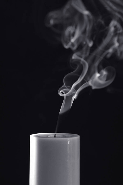 White Candle with white smoke on black background  - Foto, afbeelding
