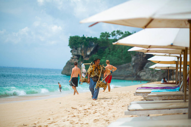 Surfer. Surfing Man With Surfboard Walking On Sandy tropical Beach. Healthy Lifestyle, water activities, Water Sport. Beautiful Ocean.  - Fotografie, Obrázek