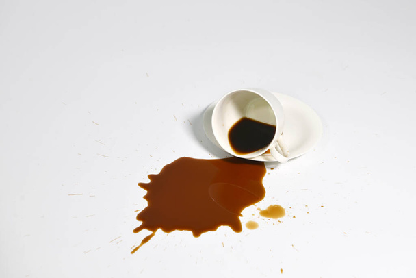 Spilled coffee from glass isolated on white - Foto, imagen