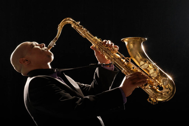 Man Playing Saxophone side view - 写真・画像