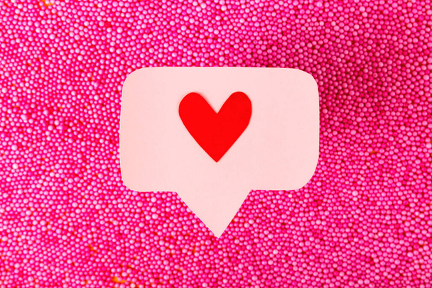 Pembe topların üzerindeki pembe bir iğne üzerindeki kalp ikonu gibi kırmızı. Sosyal ağlar kavramında birçok emoji kalbi - Fotoğraf, Görsel