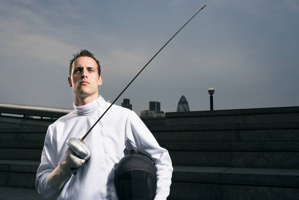Fencer holding sword outdoors portrait - Foto, immagini