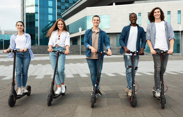 Felices amigos teniendo buen paseo en scooters motorizados
 - Foto, imagen