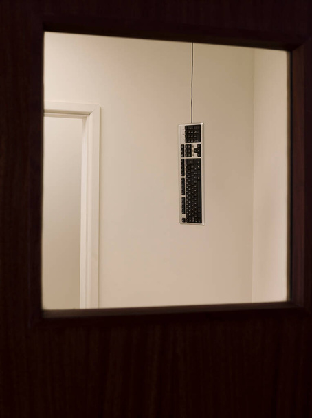 Keyboard hanging from ceiling - Zdjęcie, obraz