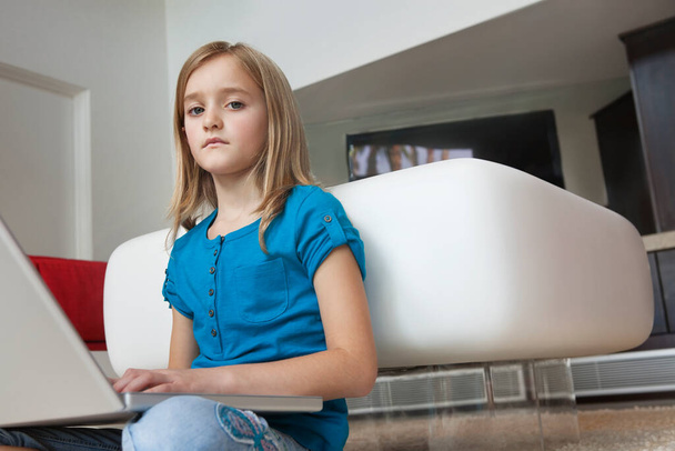 Portrait of young girl with laptop sitting in house - Photo, Image