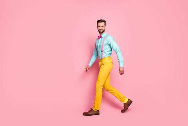 Full length body size profile side view of his he nice attractive elegant luxury brandy funky cheery brunet guy walking corporate event isolated over pink pastel color background - Foto, Imagem