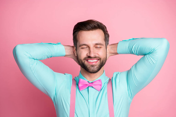 Close-up portrait of his he nice attractive handsome fashionable dreamy cheerful cheery bearded guy wearing festal blue shirt resting isolated over pink pastel color background - Φωτογραφία, εικόνα