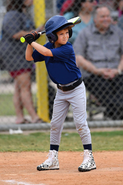 Action photo of handsome young baseball player making amazing plays during a baseball game - Photo, Image