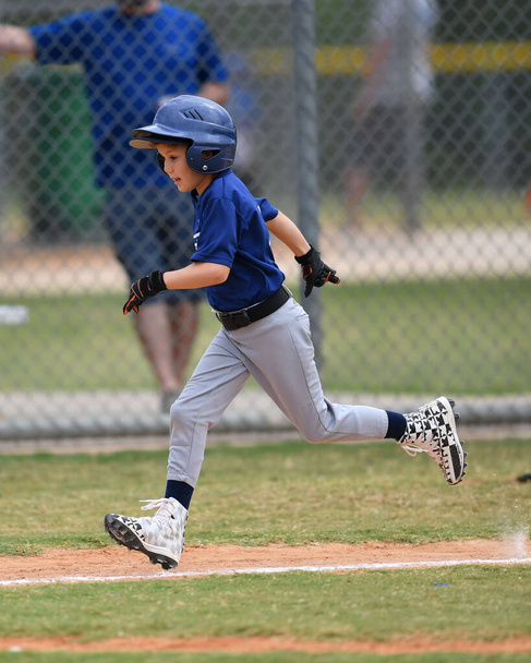 Akció fotó jóképű fiatal baseball játékos, hogy csodálatos játszik közben egy baseball játék - Fotó, kép