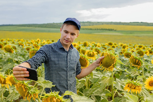 young farmer blogger influencer recording video blog concept speaking looking at smartphone - Фото, зображення