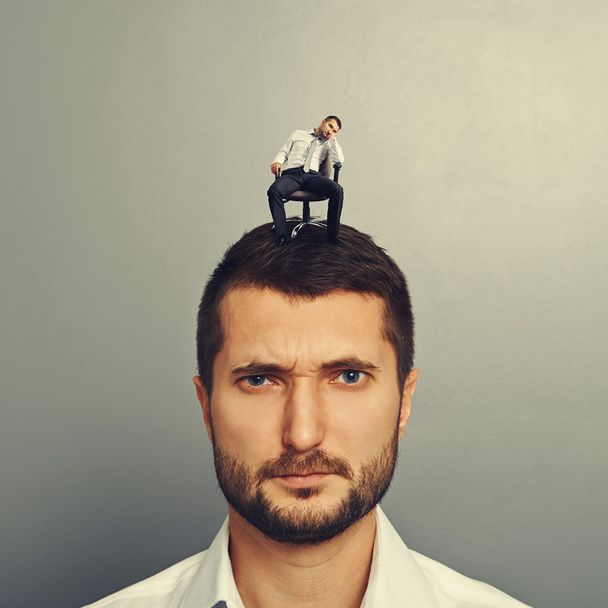 bored man sitting on the big head - Photo, Image