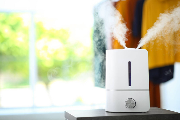 Modern air humidifier on table indoors. Space for text - Photo, Image
