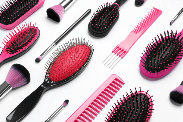 Composition with modern hair combs and brushes on white background, above view - Foto, imagen
