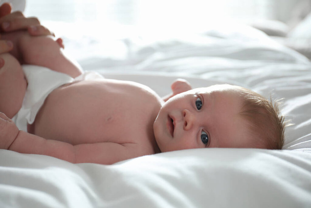 Cute little newborn baby on bed, closeup - Zdjęcie, obraz