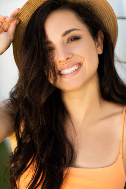 Pretty brunette girl in a straw hat feeling amazing - Foto, imagen