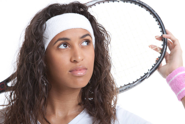 Sporty young woman with tennis racket looking away against white background - Foto, Imagem