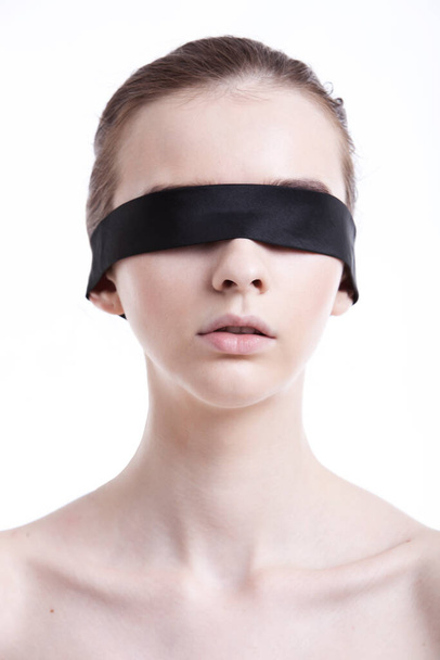 Shirtless young woman blindfolded against white background - Foto, immagini