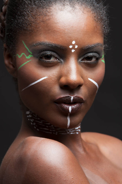 Portrait of young attractive african american woman with full make up on in studio - Фото, зображення