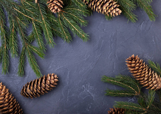Christmas tree with cones on a black background, top view with space for text. Christmas new year background - Fotó, kép