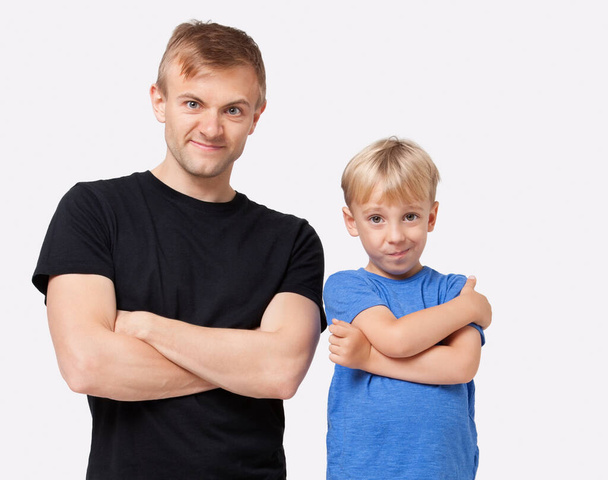 Portrait of happy father and son in casuals with arms crossed over white background - Fotoğraf, Görsel