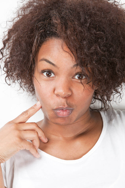 Portrait of African American young woman making funny faces - Фото, изображение