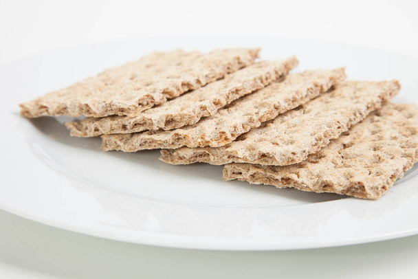 Close-up of crackers in plate on background - Fotografie, Obrázek