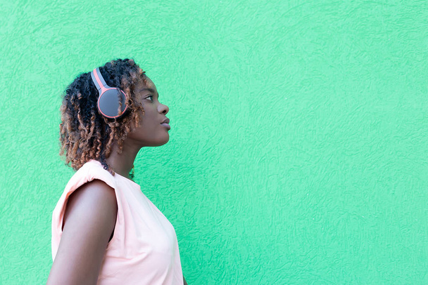 a bela mulher afro-americana em fones de ouvido na rua
 - Foto, Imagem