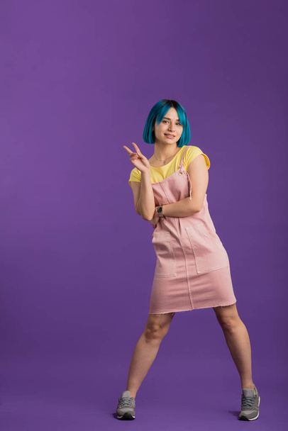 stylish girl with blue hair showing a gesture - Photo, Image