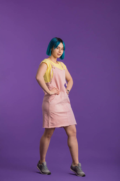 girl with unusual style in clothes and dyed hair posing to the camera - Foto, afbeelding