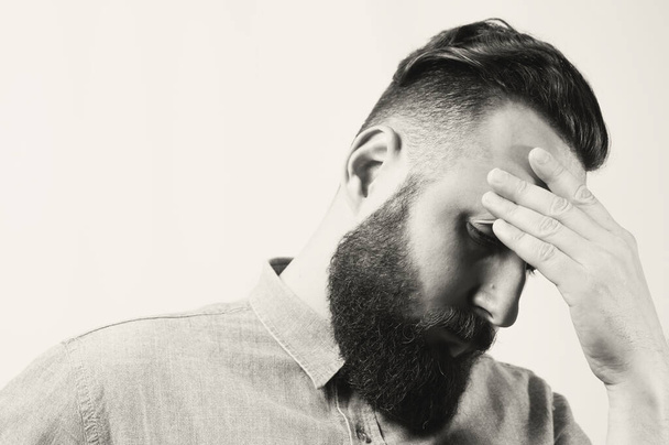 Black and white portrait of sad bearded man with fashion haircut. - Photo, Image