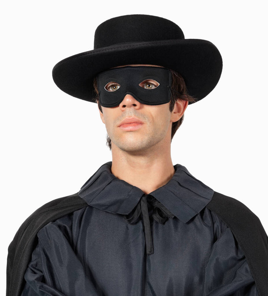 Thoughtful young man dressed as Zorro against gray background - Фото, зображення