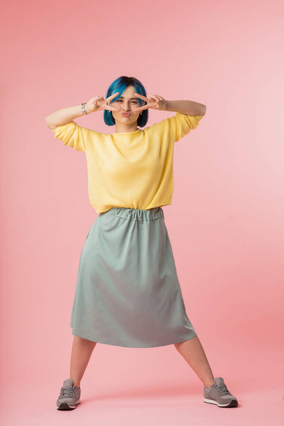 funny attractive girl in fashion skirt, yellow sweater and blue hairstyle - Fotografie, Obrázek