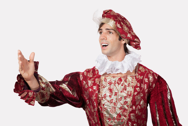 Young man in old-fashioned costume against gray background - Foto, Bild