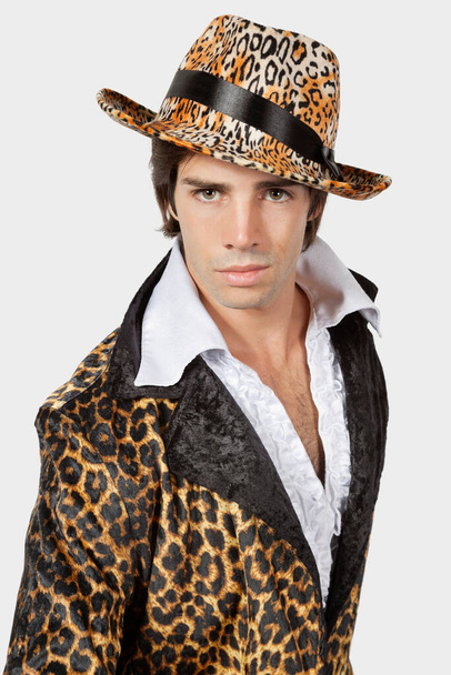 Portrait of young man in fur clothing against gray background - Фото, зображення