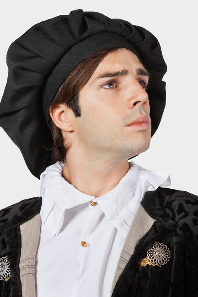 Young man in old-fashioned costume against gray background - Φωτογραφία, εικόνα
