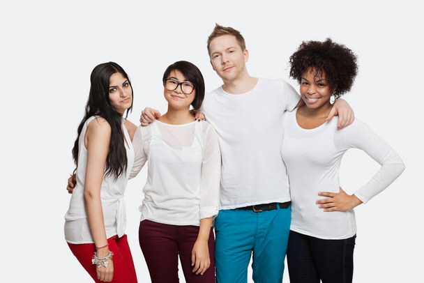 Portrait of multi-ethnic friends in casuals smiling over white background - Foto, Imagem