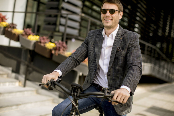 Handsome young businessman on the ebike at the street - Fotoğraf, Görsel