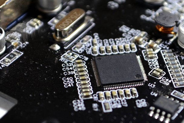 Printed Circuit Board with many electrical components. Electronic circuit, microchip on board - Fotografie, Obrázek