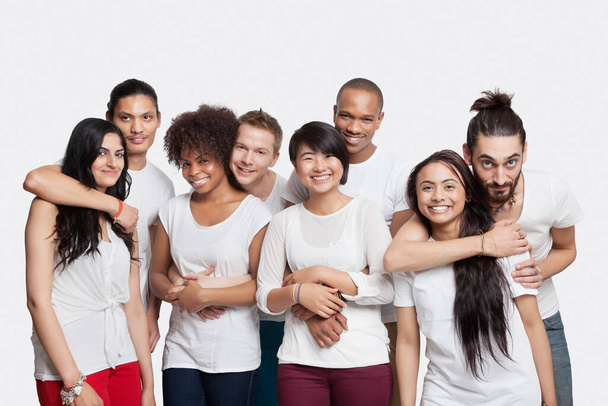 Portrait of four young couples smiling together against white background - Foto, Bild