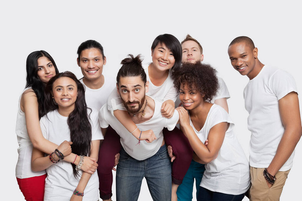 Portrait of cheerful young multi-ethnic friends against white background - Фото, зображення