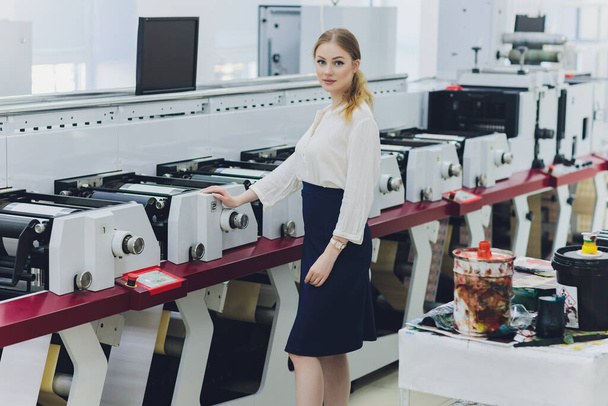 Young woman working in printing factory. Printing Press. - Valokuva, kuva