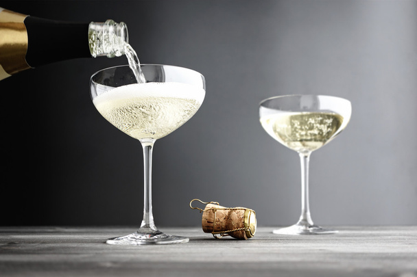 Champagne being filled in Coupe Glasses - 写真・画像