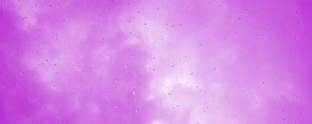 Achtergrond abstract met waterdruppels op een ruit in roze  - Foto, afbeelding