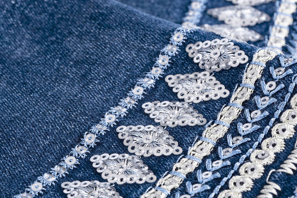 Брюки в синих джинсах Наручники украшены причудливым сшиванием и последовательностью - Фото, изображение