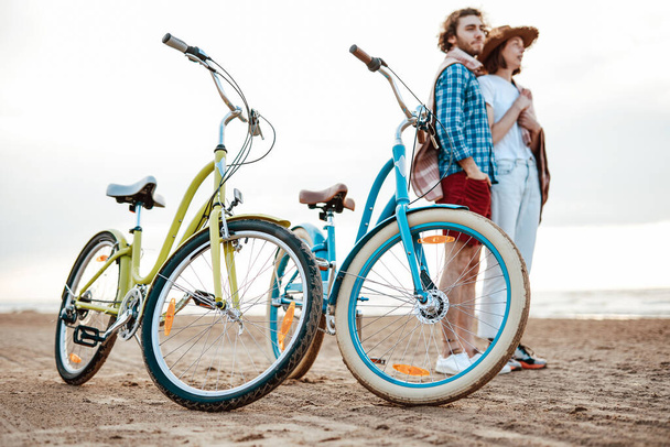 Couple, looking at the sea with two bikes in front of them - Photo, Image