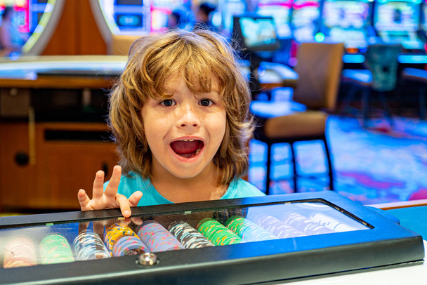 Happy boy in the casino. Gambling. Entertainment and leisure. Casino chips. Child. - Photo, Image