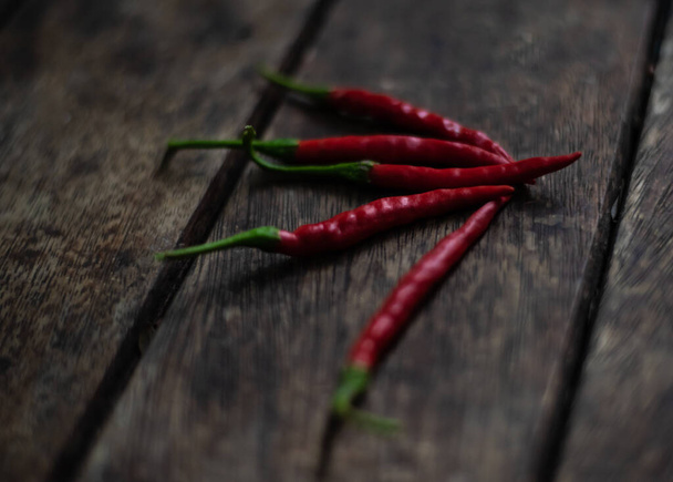 Red chilli on wood table. - Photo, Image